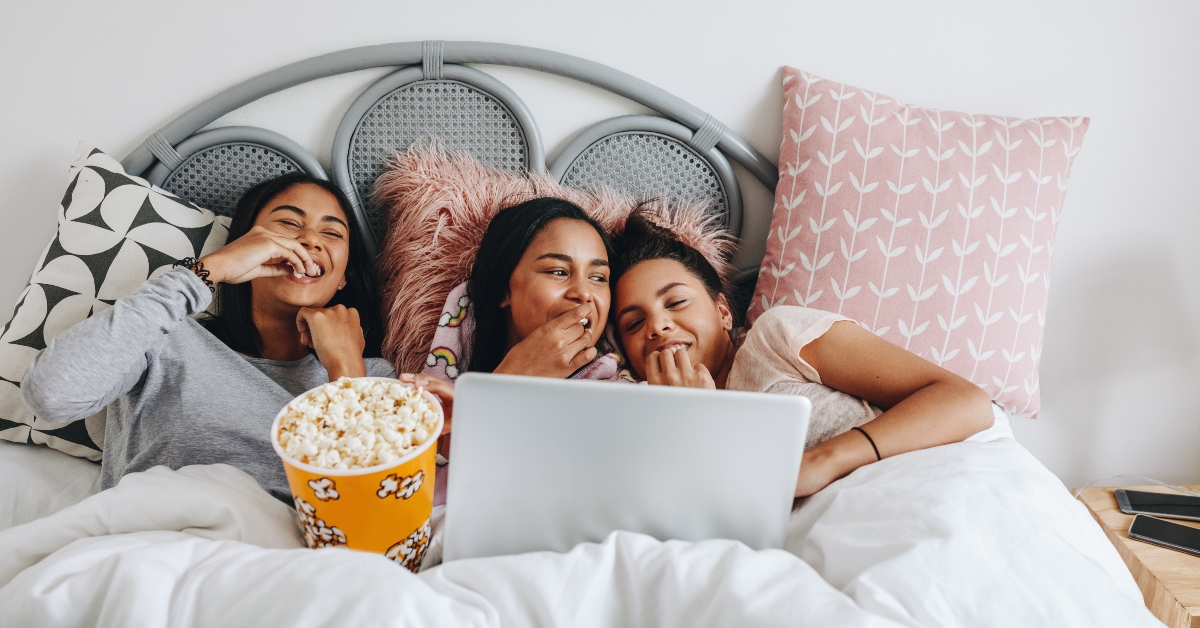 girls enjoying a movie on laptop