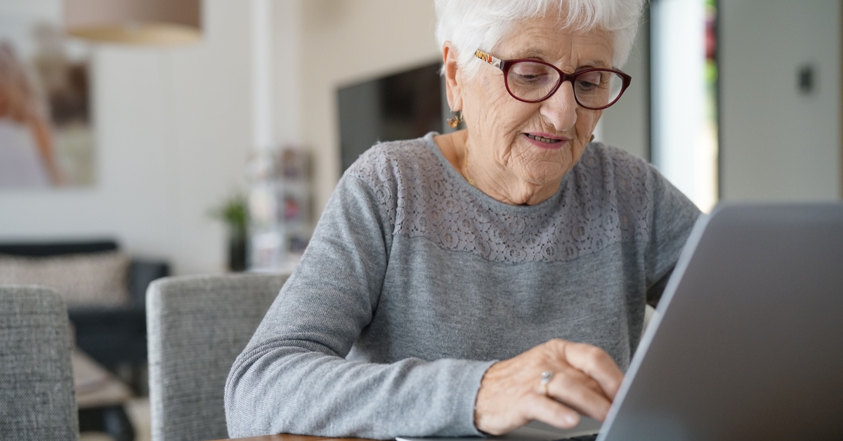 old woman at home using laptop 
