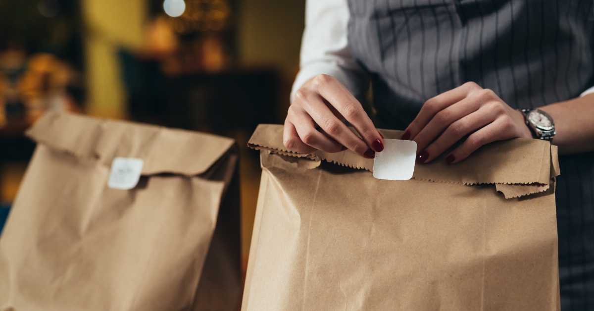 waitress preparing take away food in restaurant