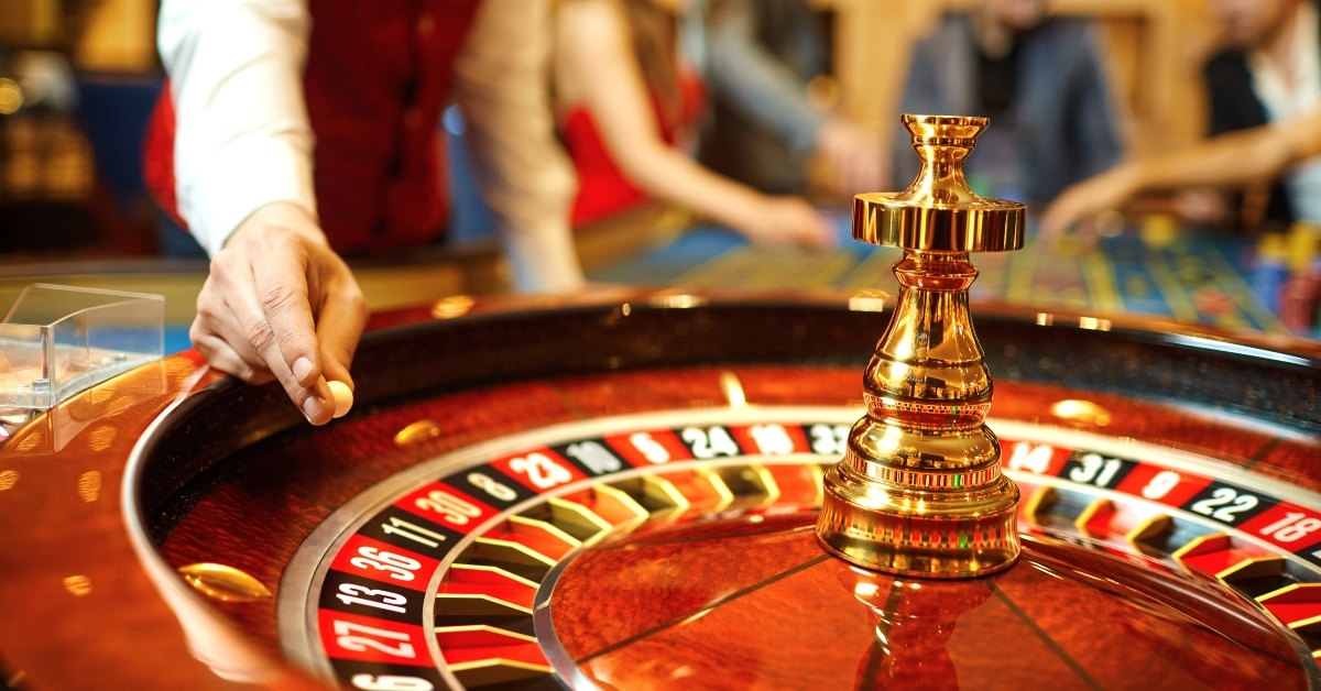 croupier holds a roulette ball