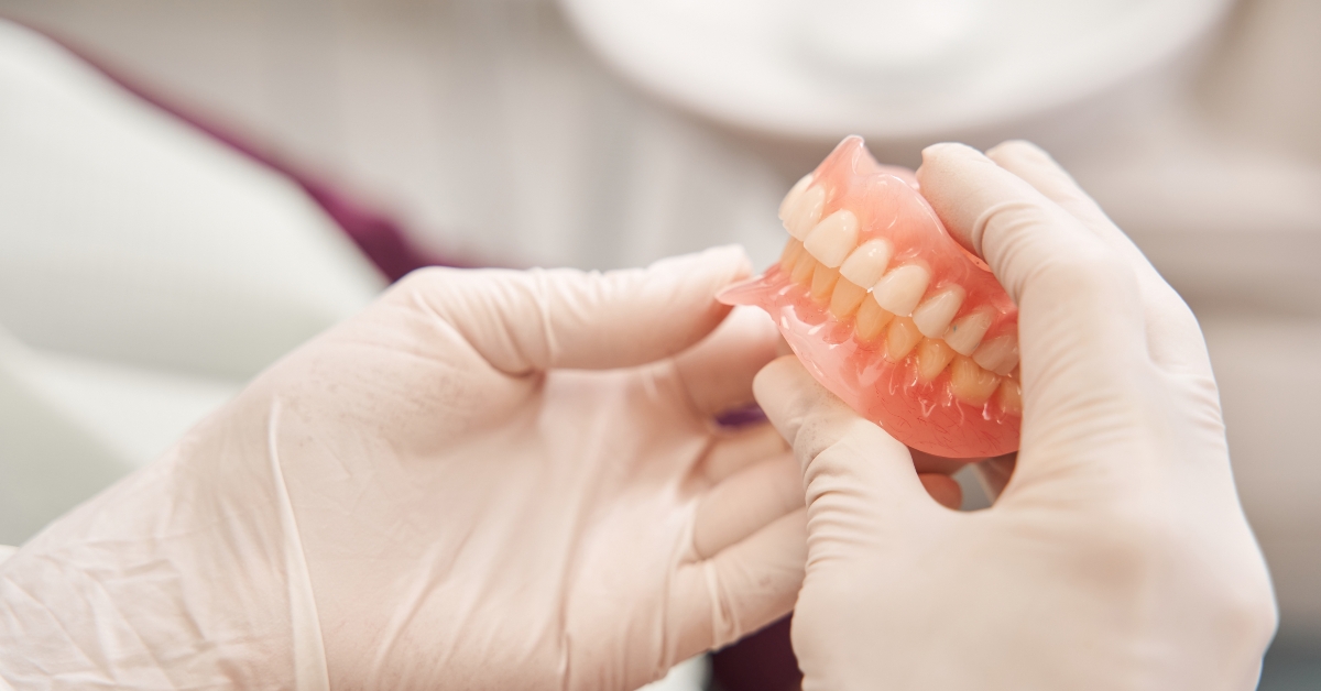 Dentist holding dentures in her hands