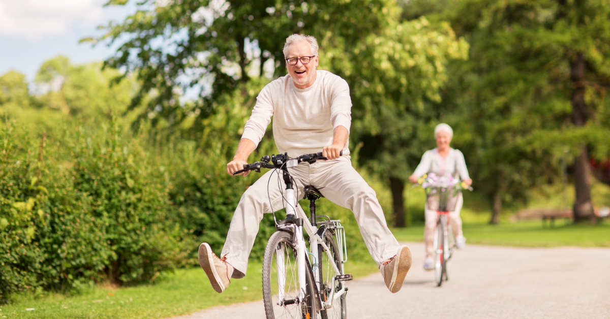 happy senior couple riding bicycles