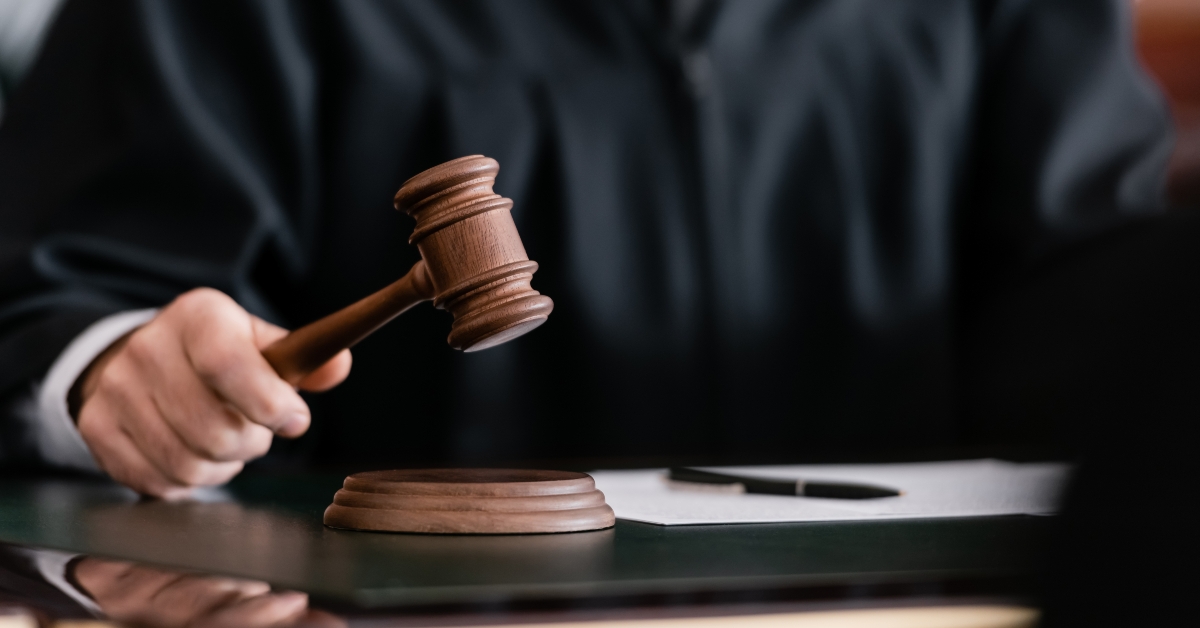 blurred judge in robe holding gavel