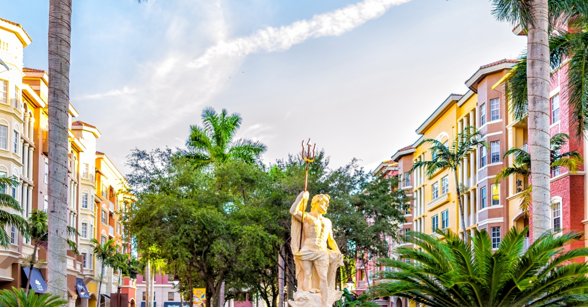 Naples, Florida Bayfront street condo architecture building colorful multicolored cityscape with water fountain statue of Poseidon Greek god of water
