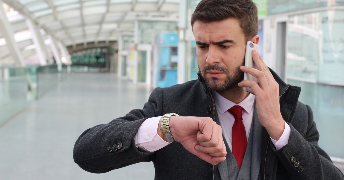 Man making a call while checking the time