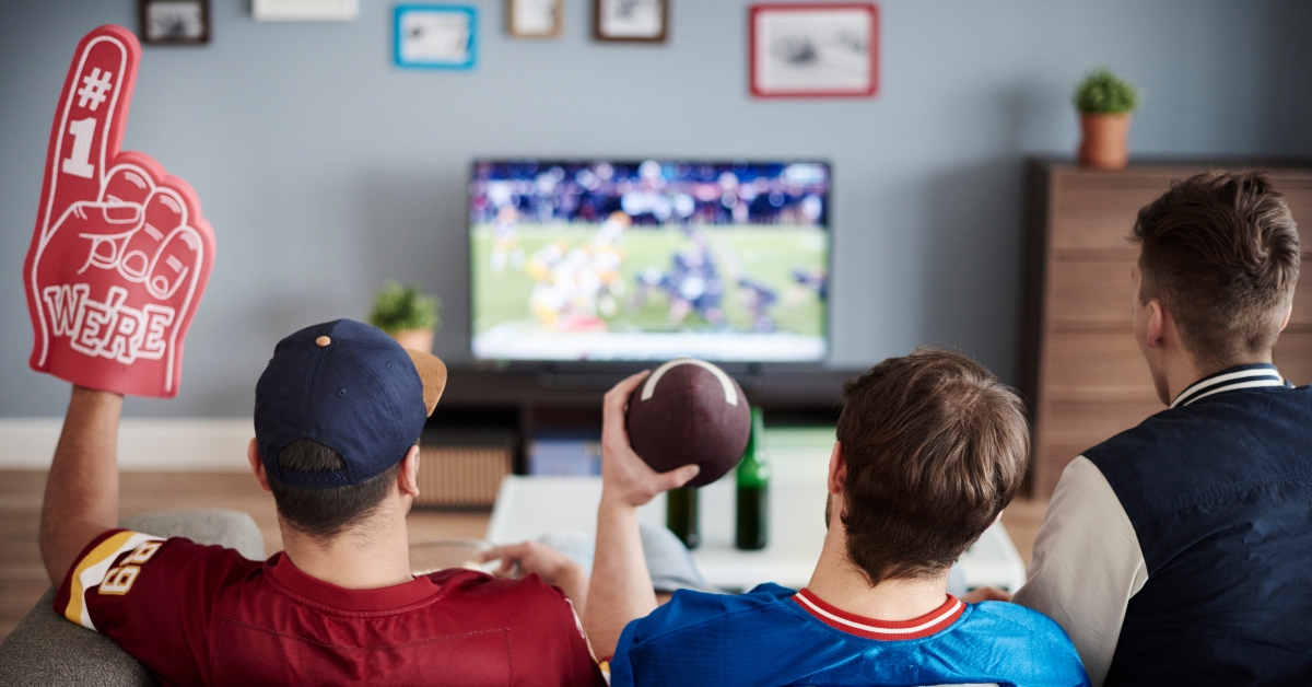three men with american football equipment