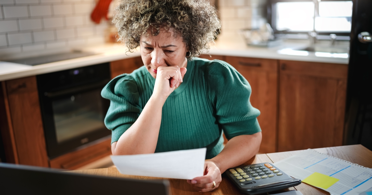 woman reviews paperwork at her kitchen