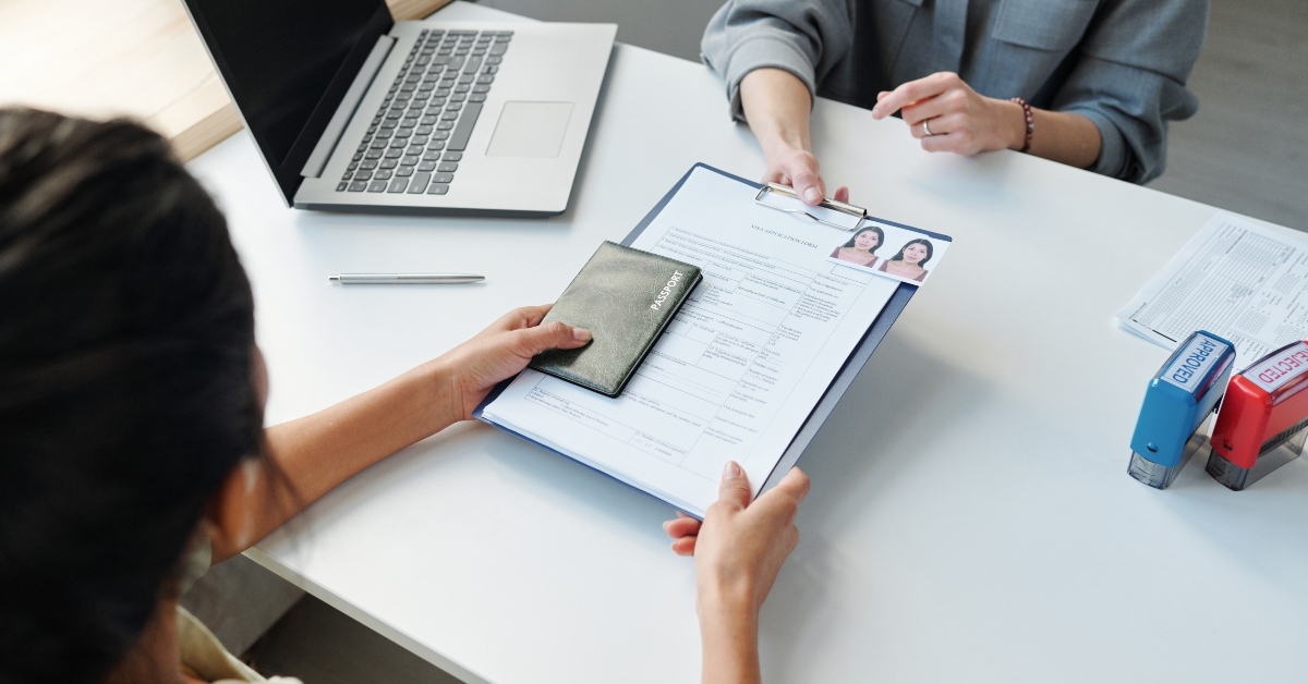 applying for visa in embassy office giving passport