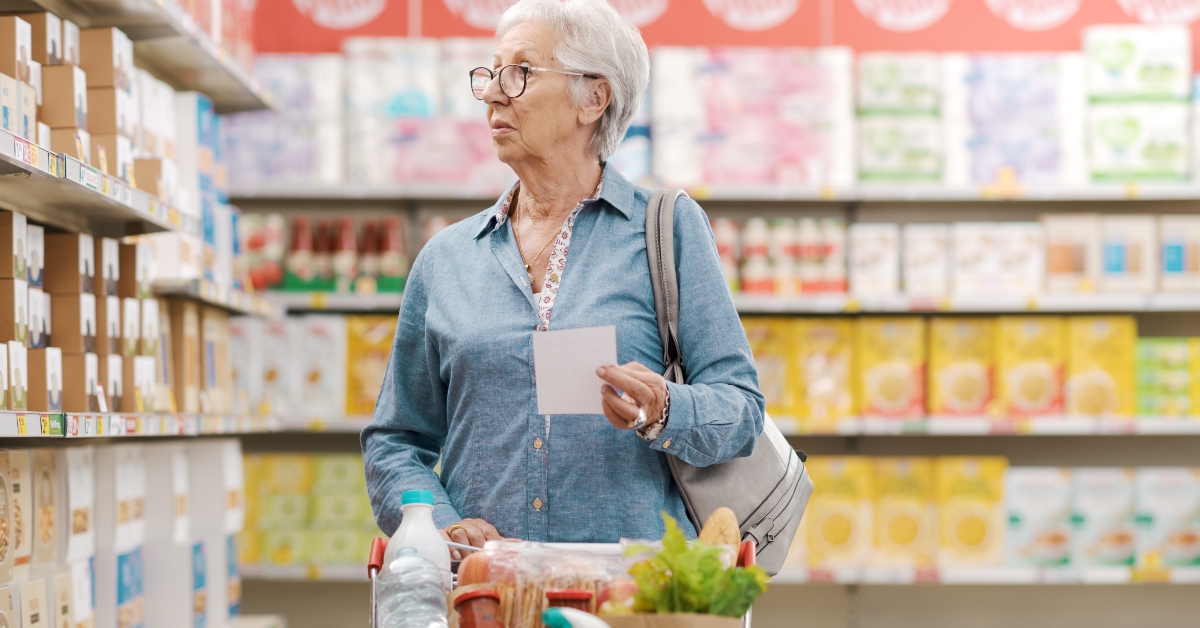 elderly woman buying groceries at the supermarket