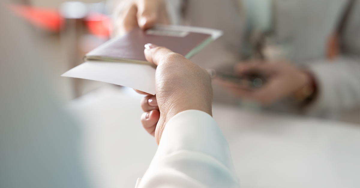businesswoman giving passport to airlines ground attendant