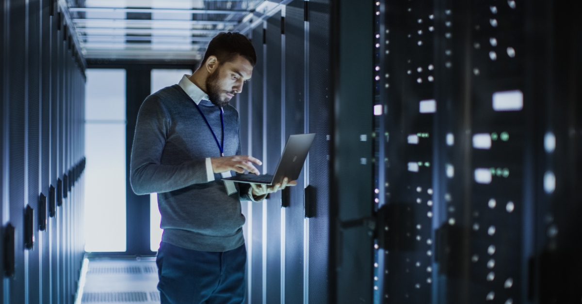 it technician works on laptop 