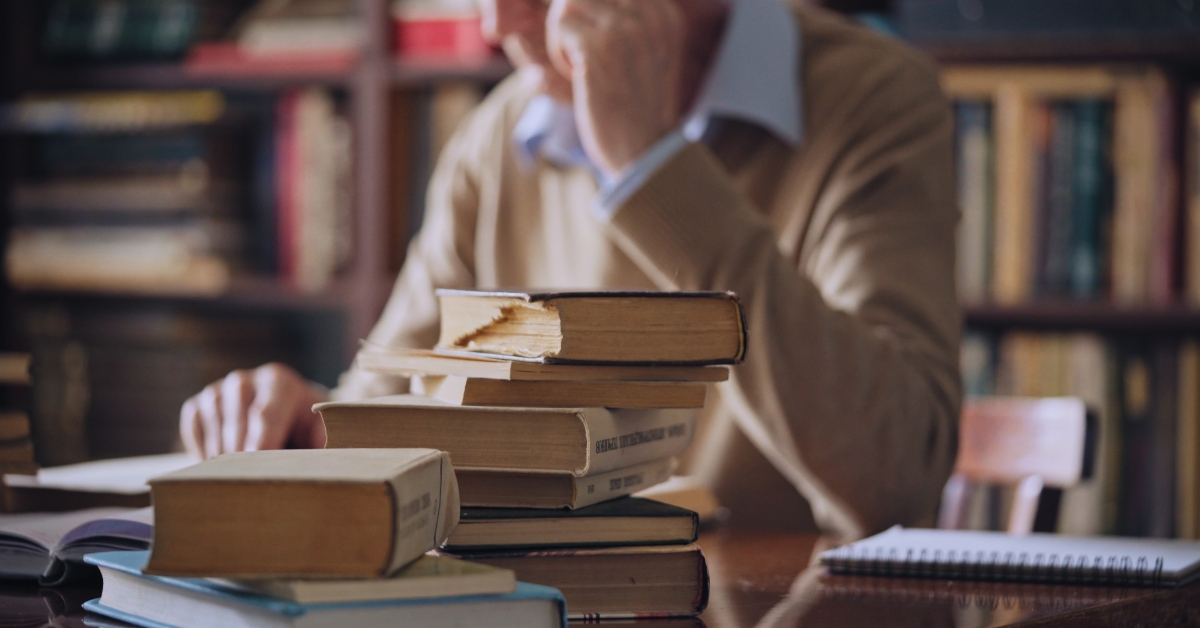 senior historian reading literature at the library