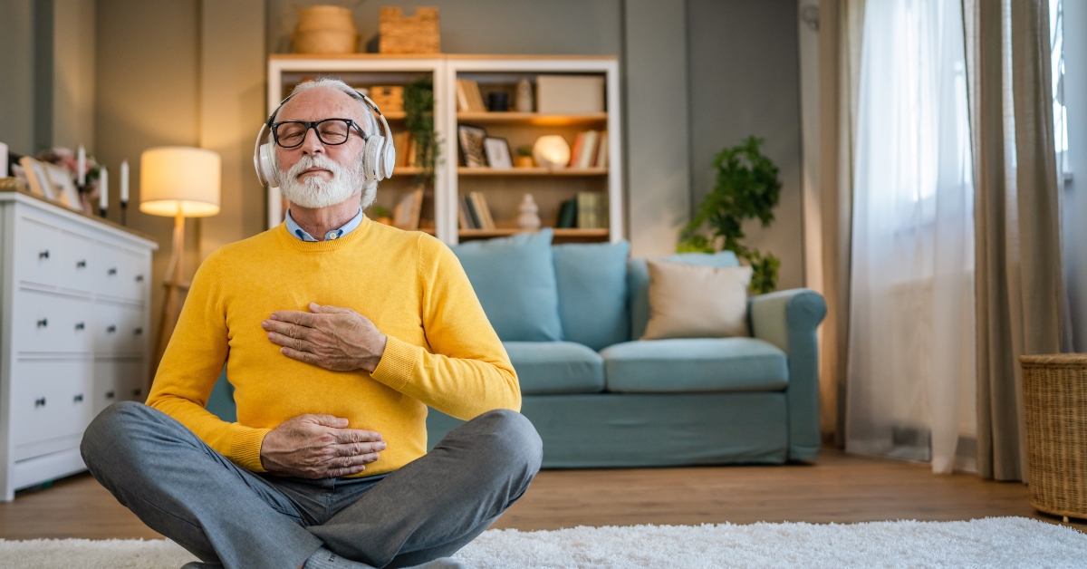 senior man practice guided meditation manifestation at home 