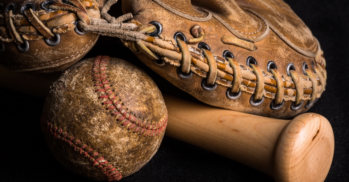 Old style mitt, baseball, and shiny bat