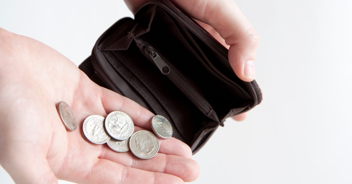 pouring coins into empty wallet