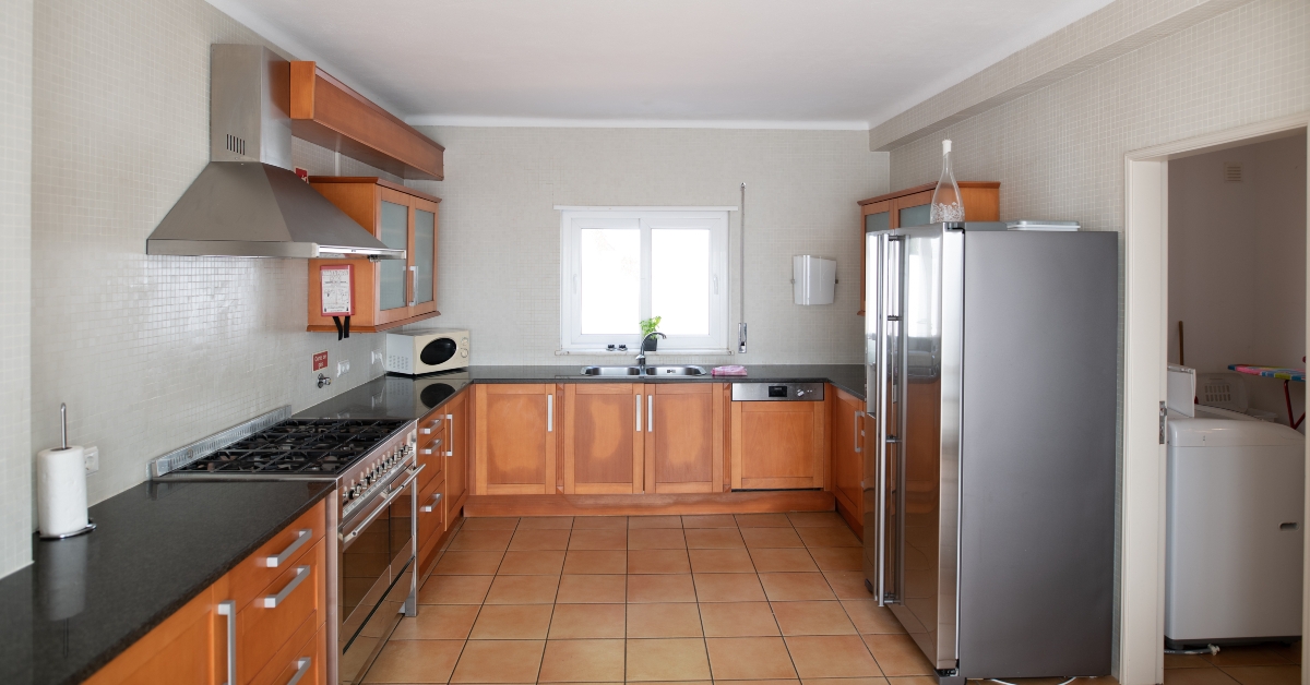 outdated kitchen with wooden cabinets