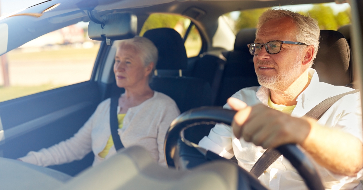 happy senior couple driving in car 