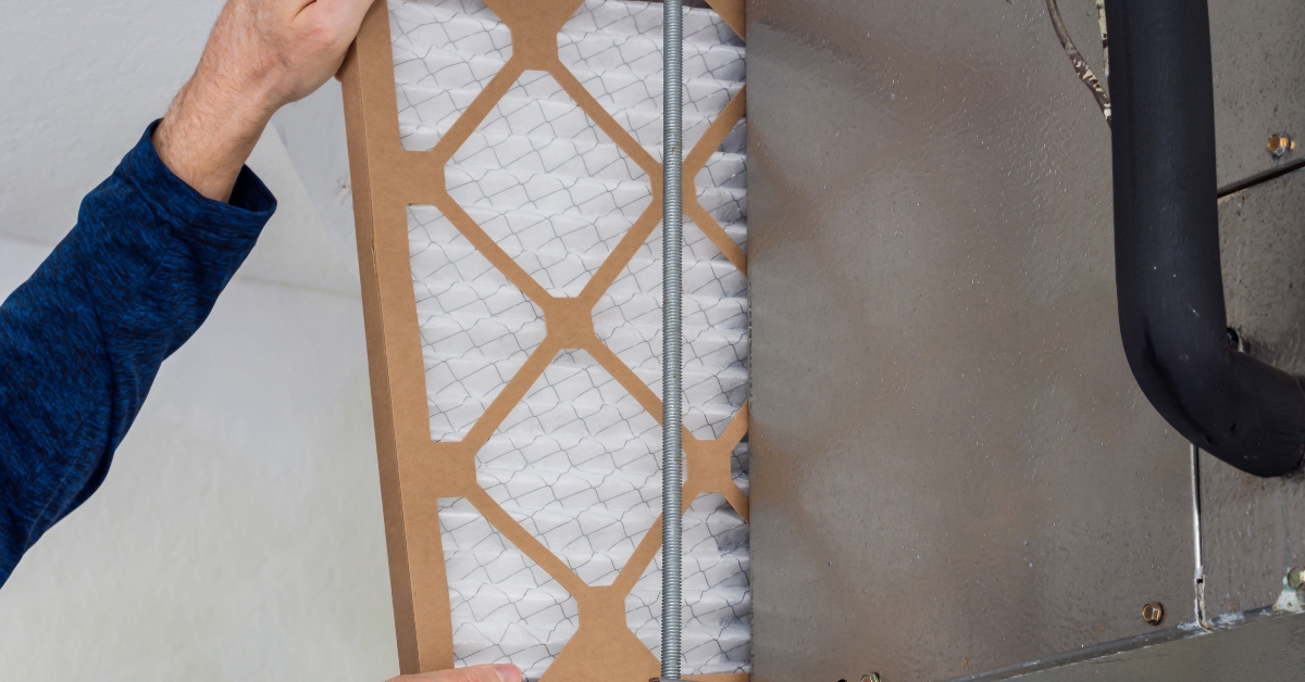 hvac service technician changing dirty indoor air filter