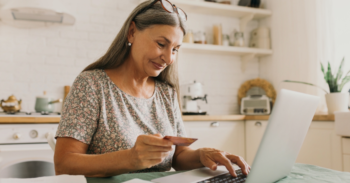 senior woman making online payments of bill using laptop