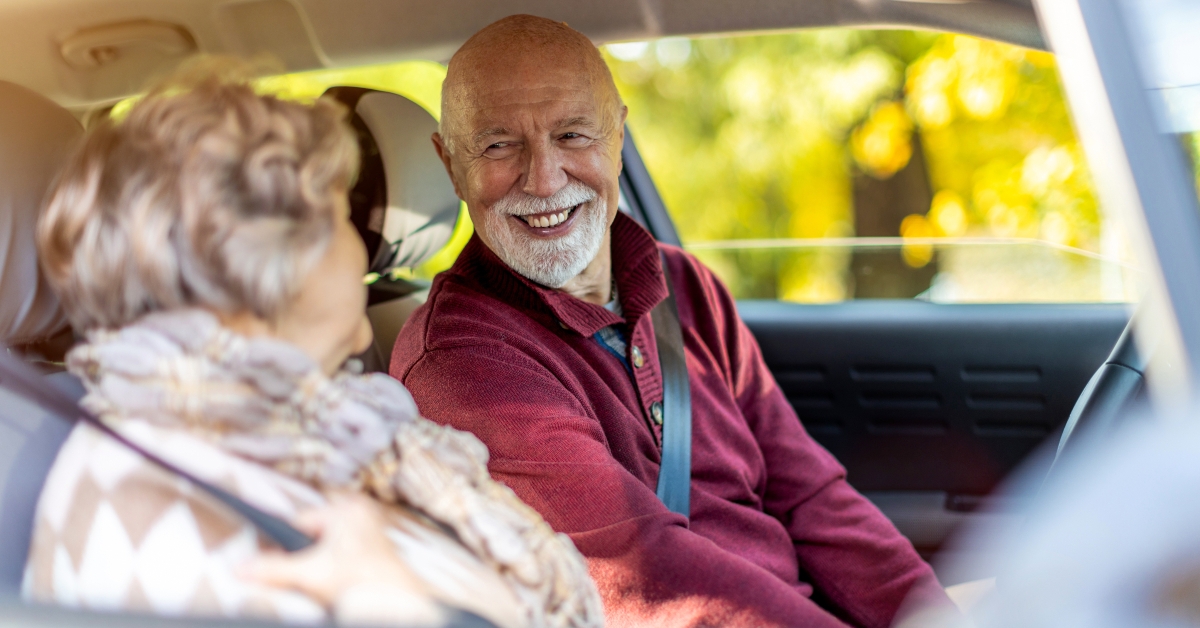 senior couple travelling in their car