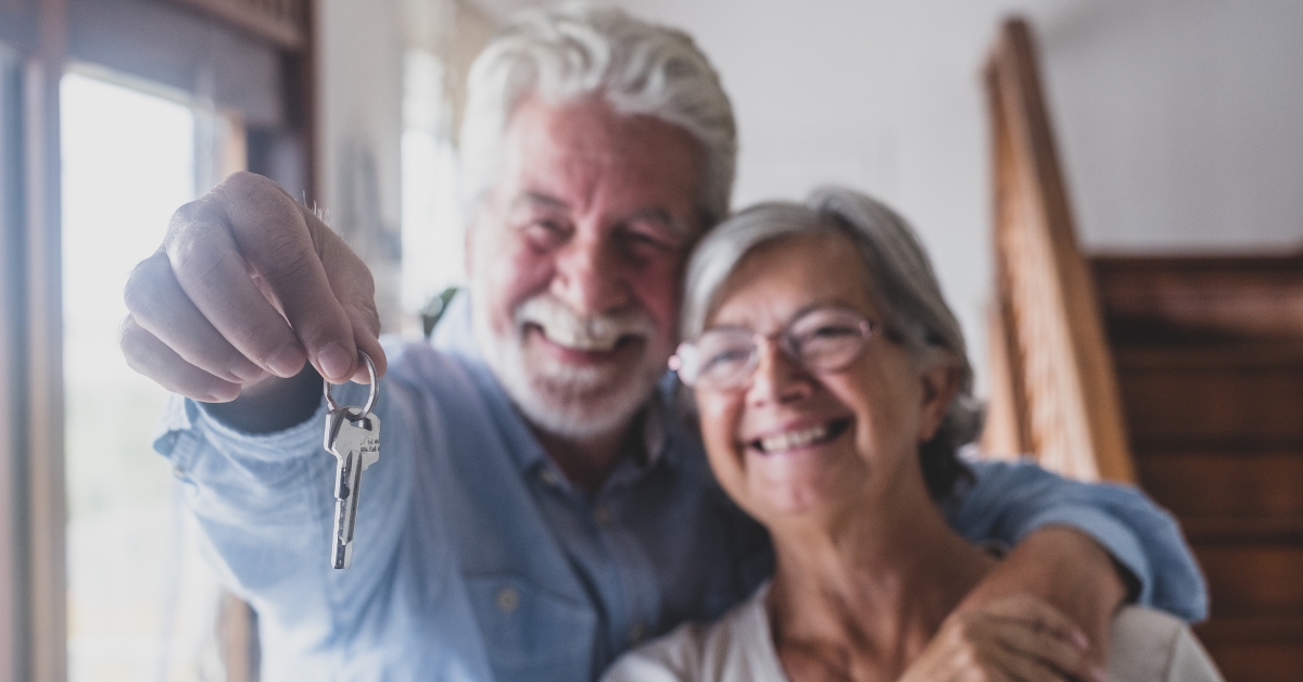 senior landlord holding key