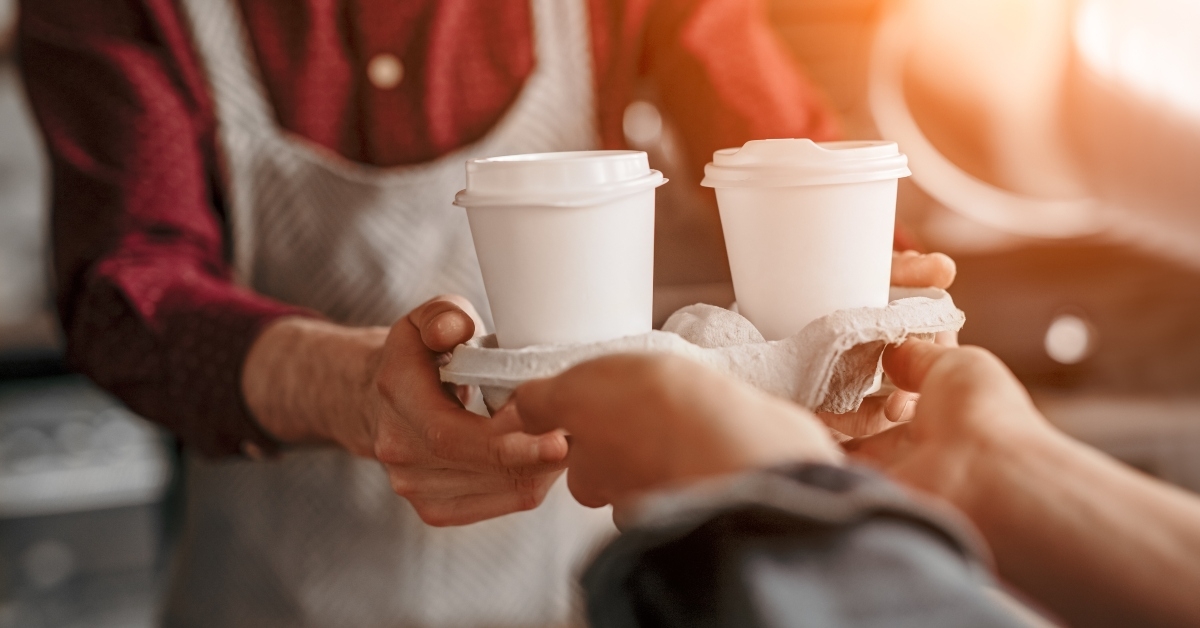 barista serving coffee in cups