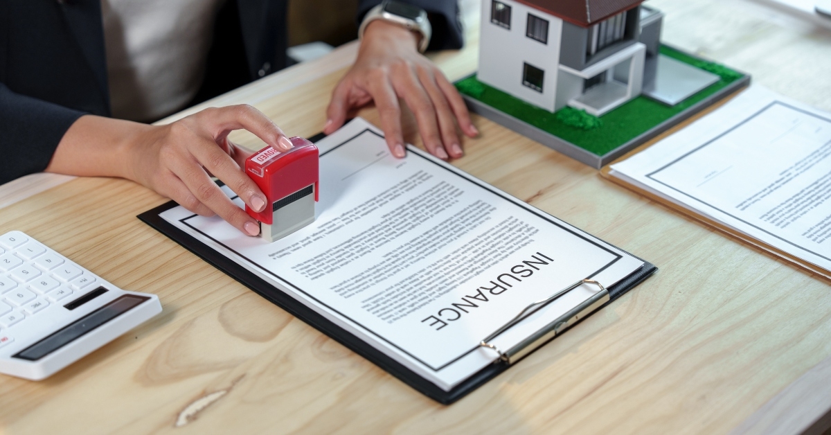 real estate agent stamping an insurance policy