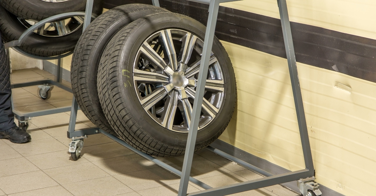 car mechanic put tires from trolley