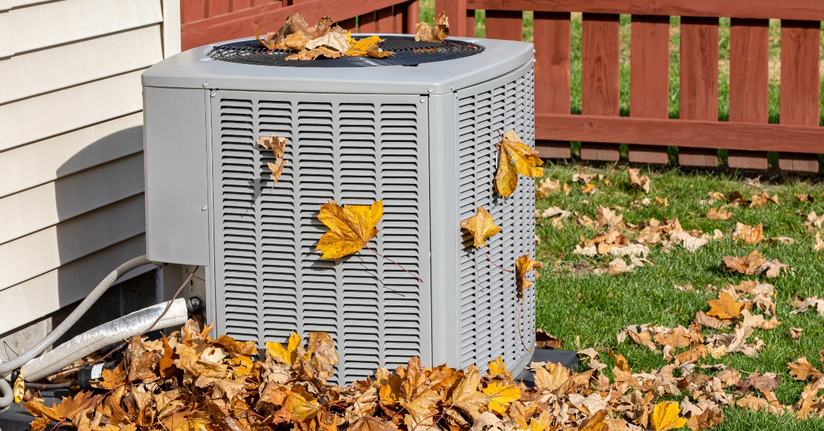 Dirty air conditioning unit cover in leaves