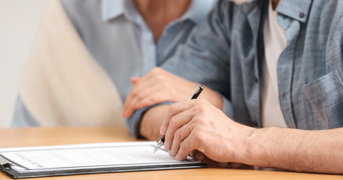 senior couple signing last will