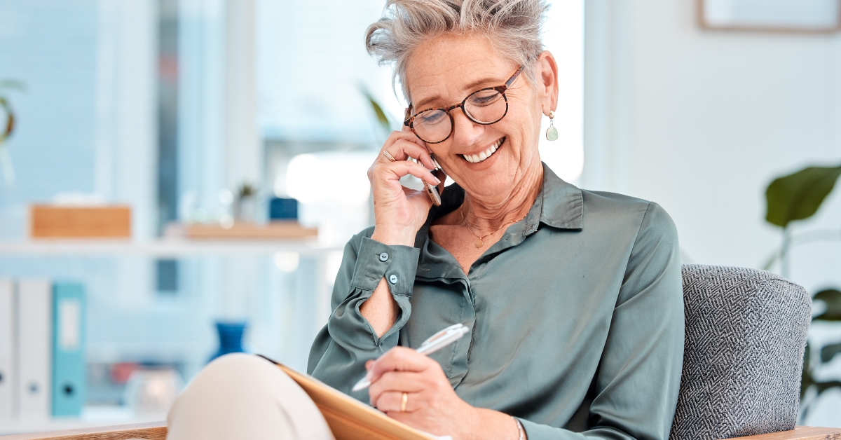 ceo talking while making an appointment in her notebook
