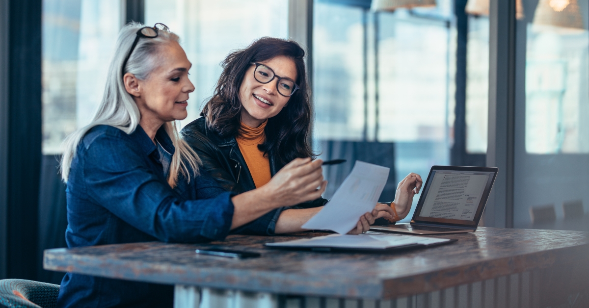 two women analyzing documents