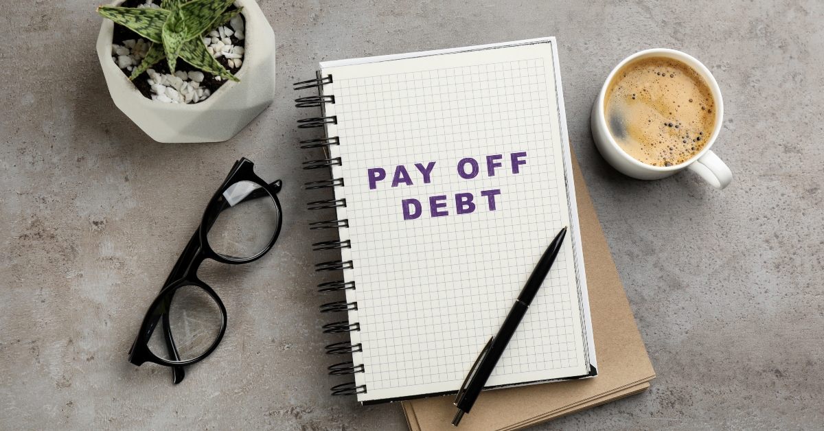 Notebook with phrase Pay Off Debt