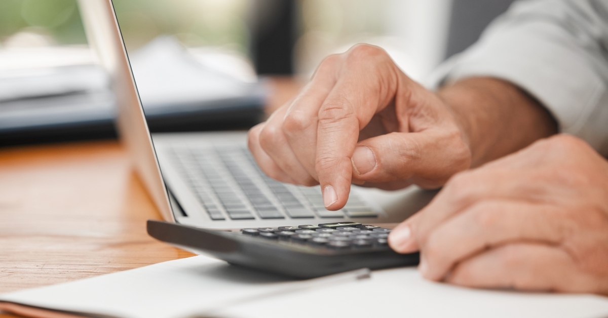 calculator laptop and hands of man calculating