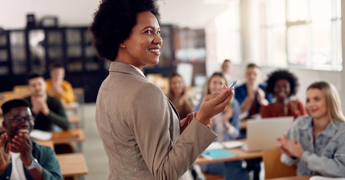 teacher getting applause from her students