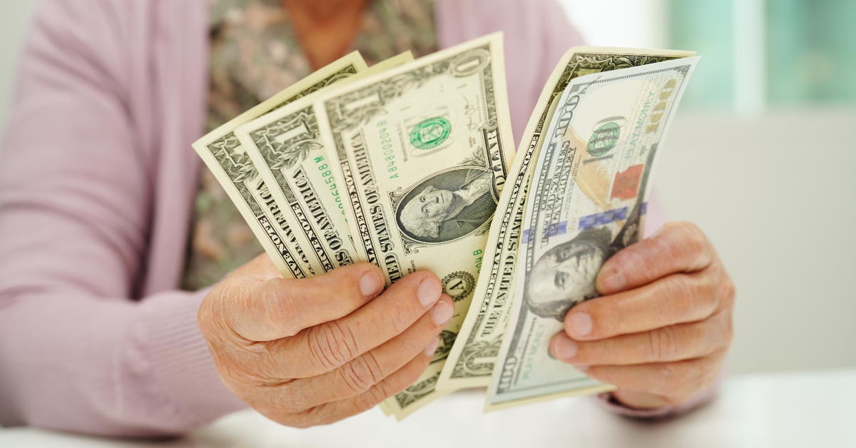 elderly woman counting money