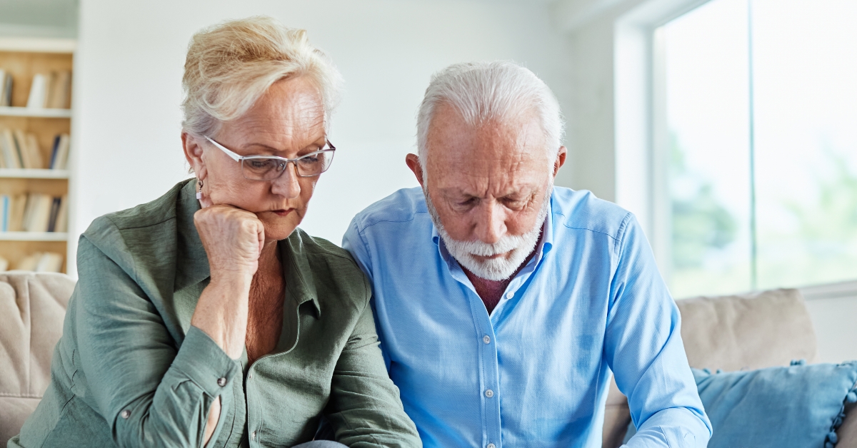 retired couple using calculator