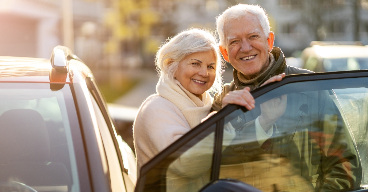 senior couple with their new car 