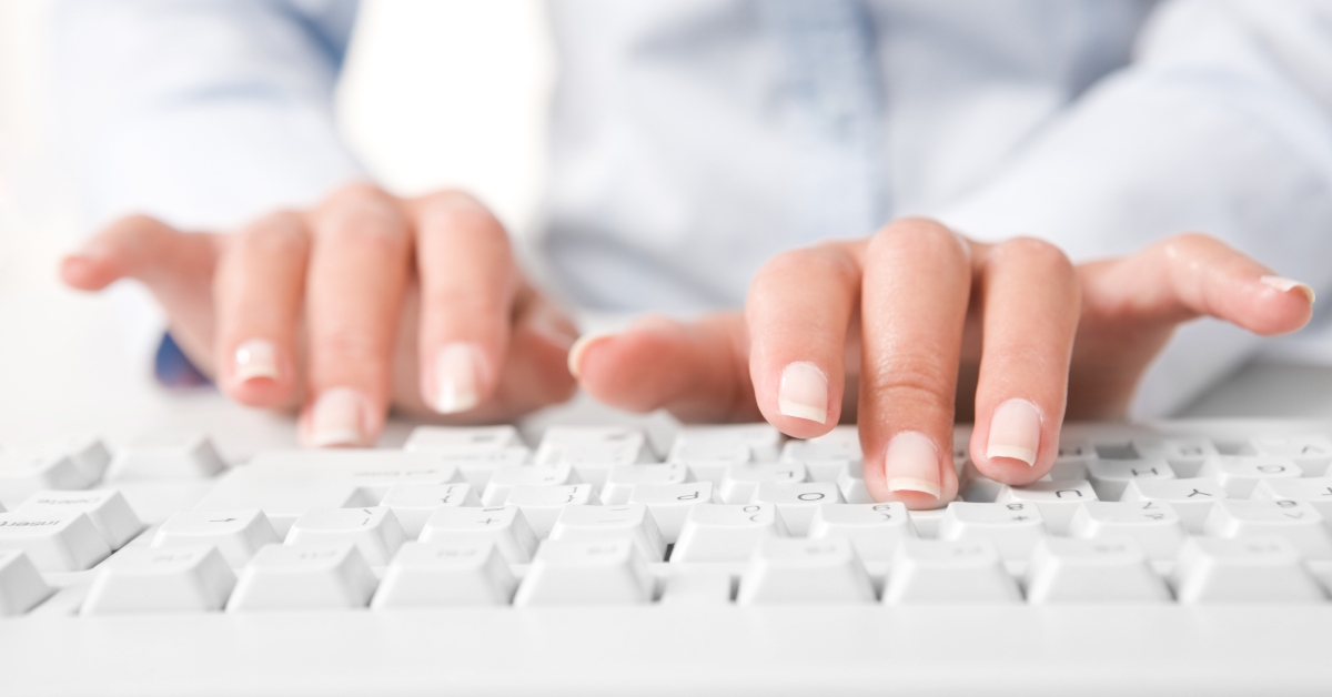 human fingers pushing the buttons of keyboard