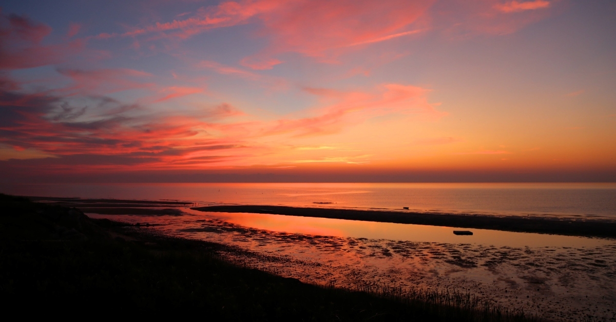 bright orange sunset over cape cod bay