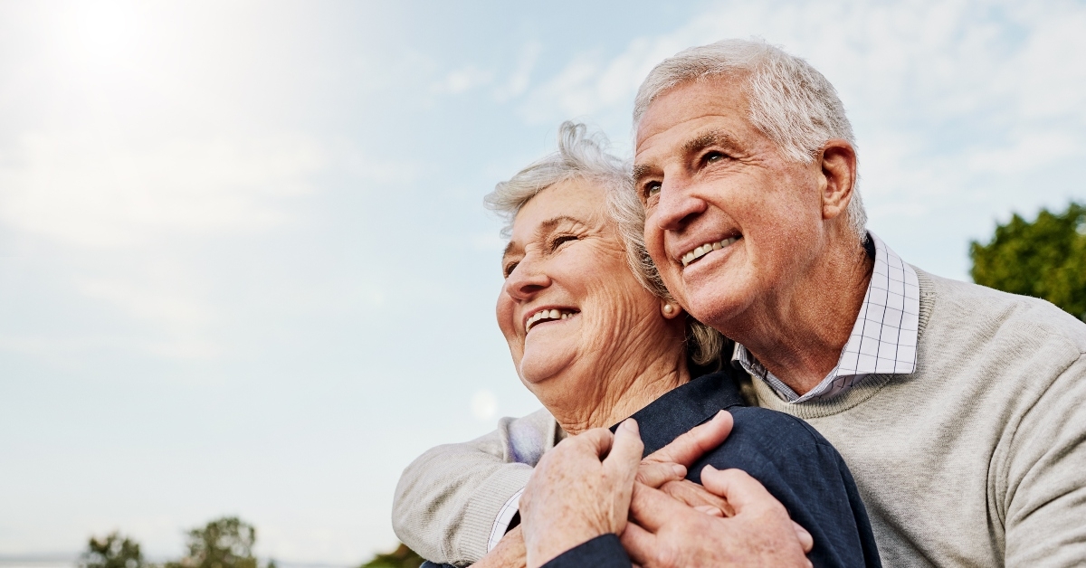 elderly couple and hug outdoors 