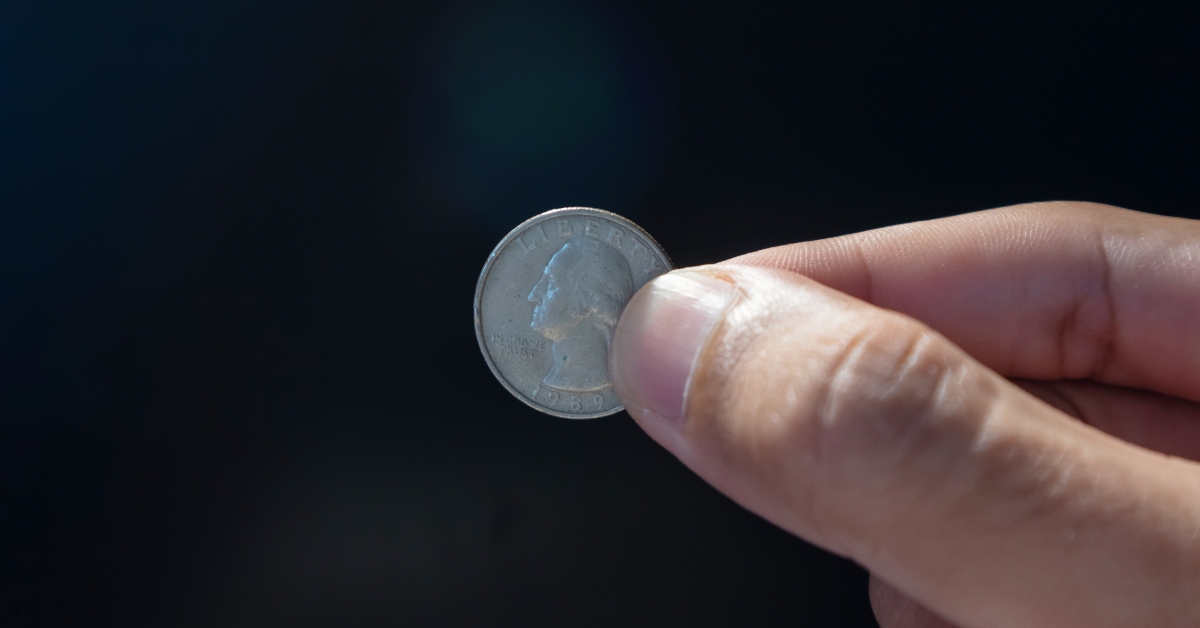 holding an old American quarter dollar