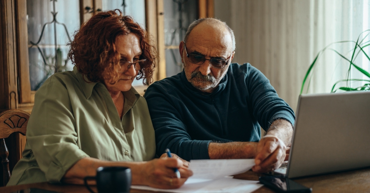 senior couple doing some paperwork at home