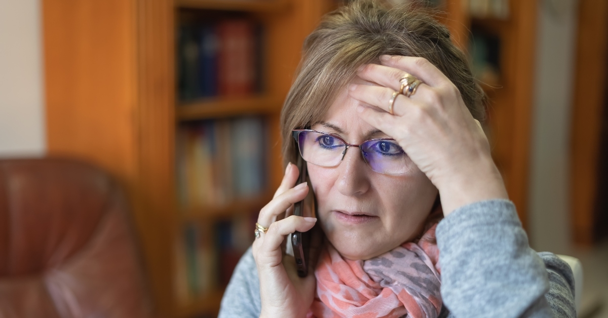 white woman talking on the phone and receiving bad news with a worried face