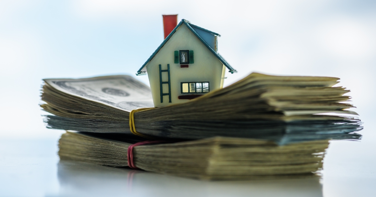 house model over dollar bills