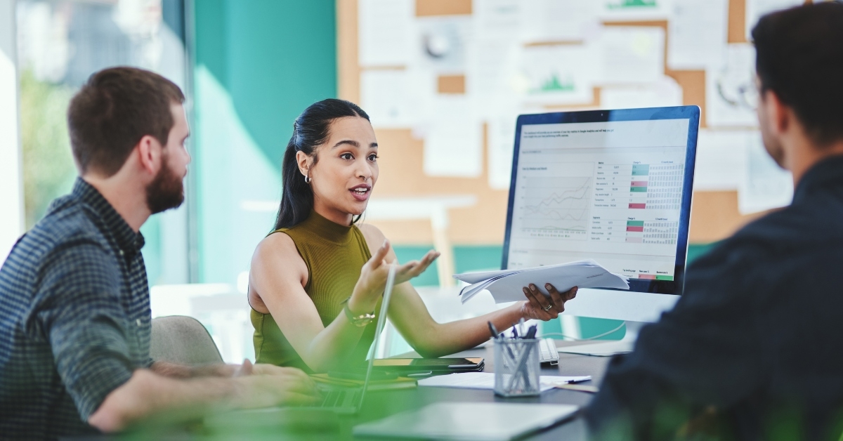 team discussion with documents in meeting
