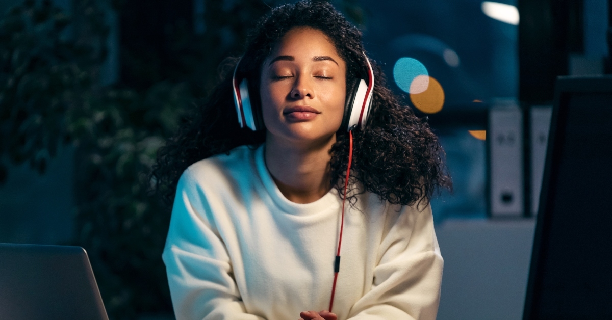 confident african woman listening to music