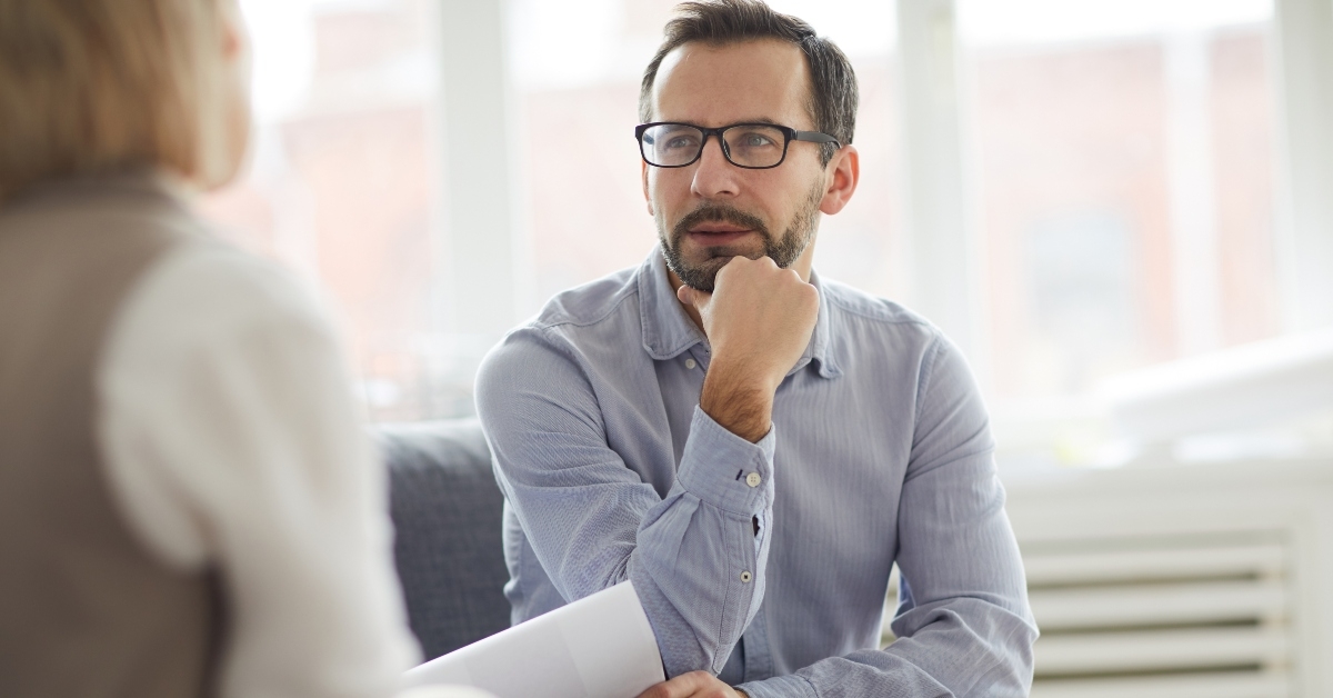 pensive counselor with paper
