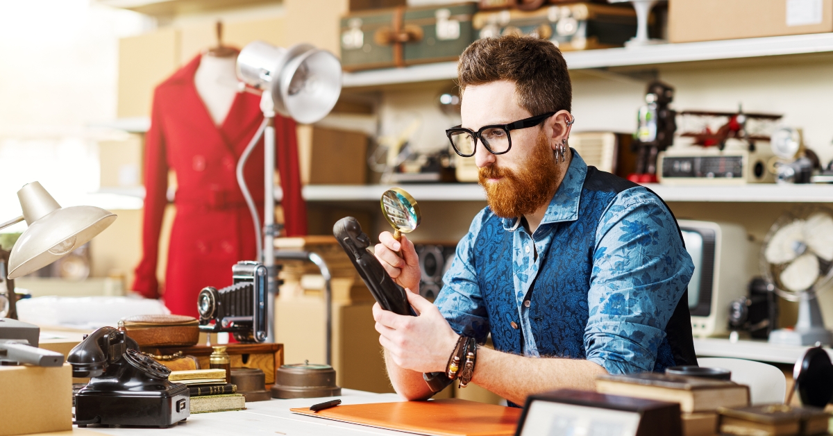 business owner checking vintage items in his shop 