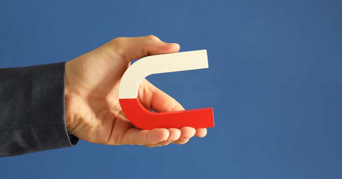 man holding horseshoe magnet